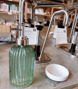 glass soap dispenser on counter at re-fill store